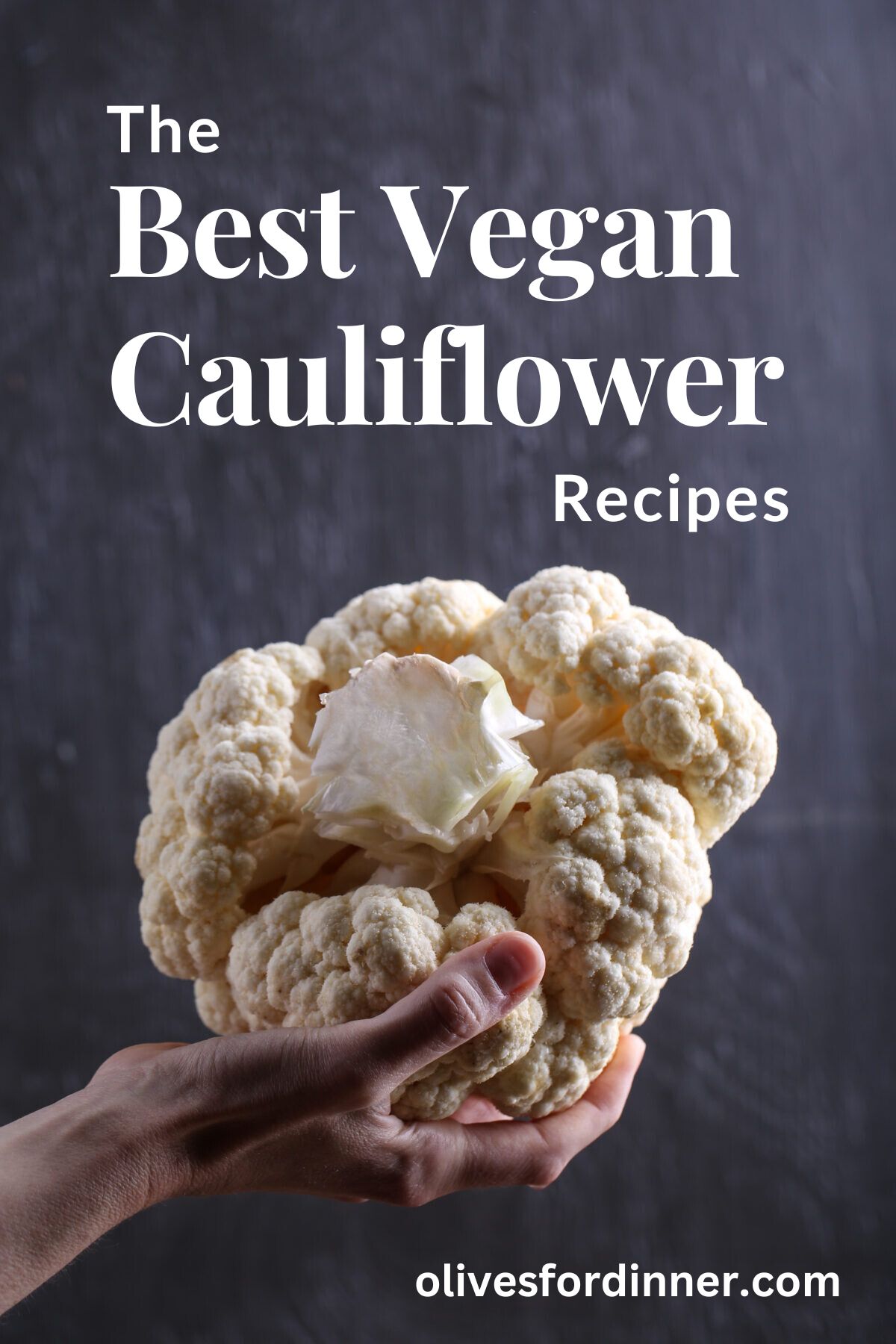 A hand holding a head of cauliflower.