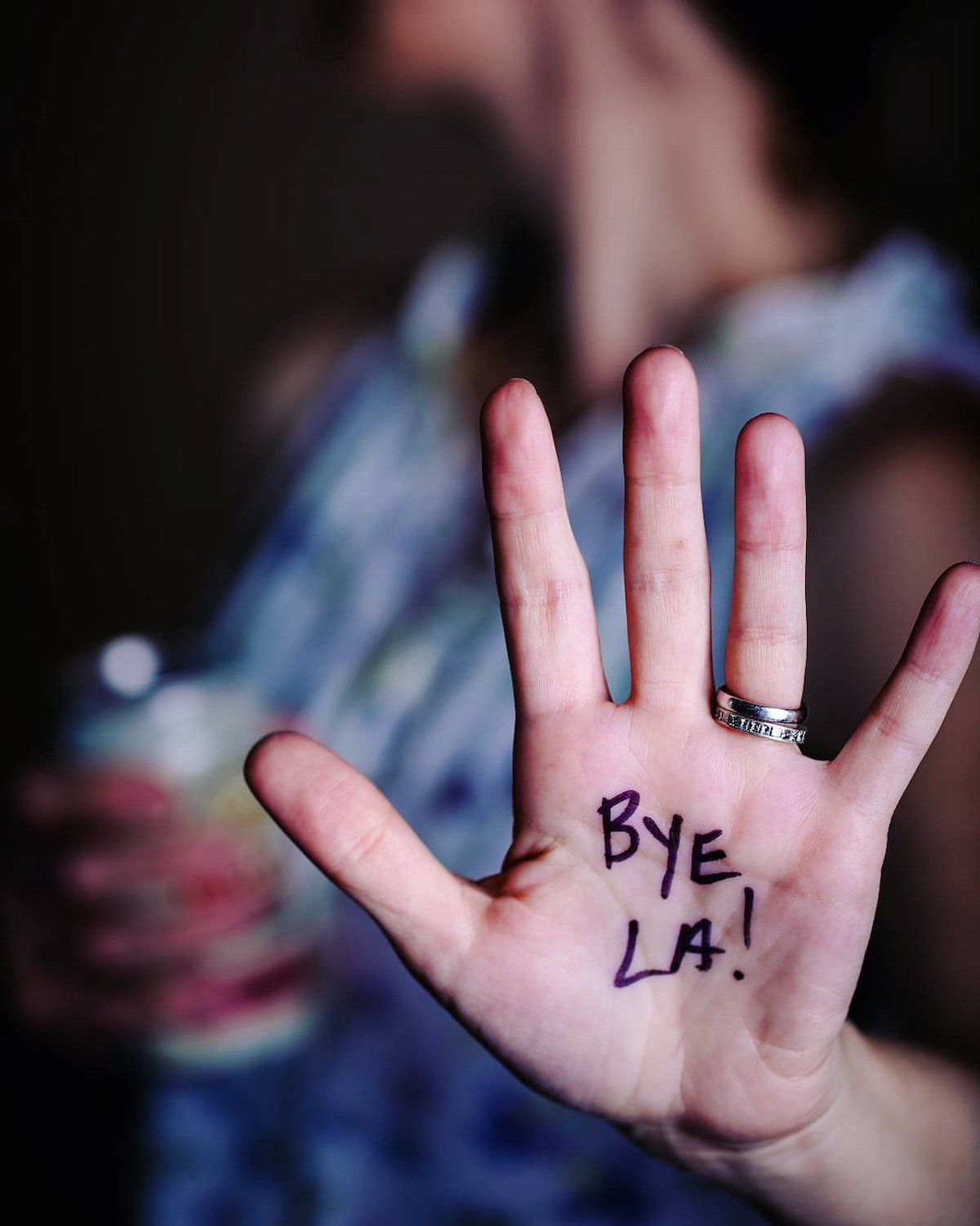 A hand with "Bye LA' written on the palm.