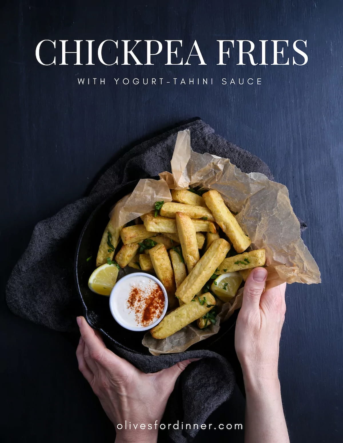 Two hands holding a plate of chickpea fries.