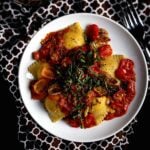 Ravioli topped with creamy tomato sauce and fresh basil.