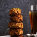 Stack of golden air fried mushrooms with a crisp sriracha-panko crust beside a cold beer.