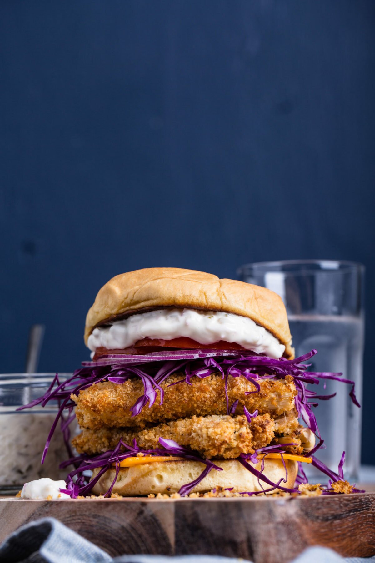 A crispy vegan fish sandwich made from hearts of palm with vegan tartar sauce.