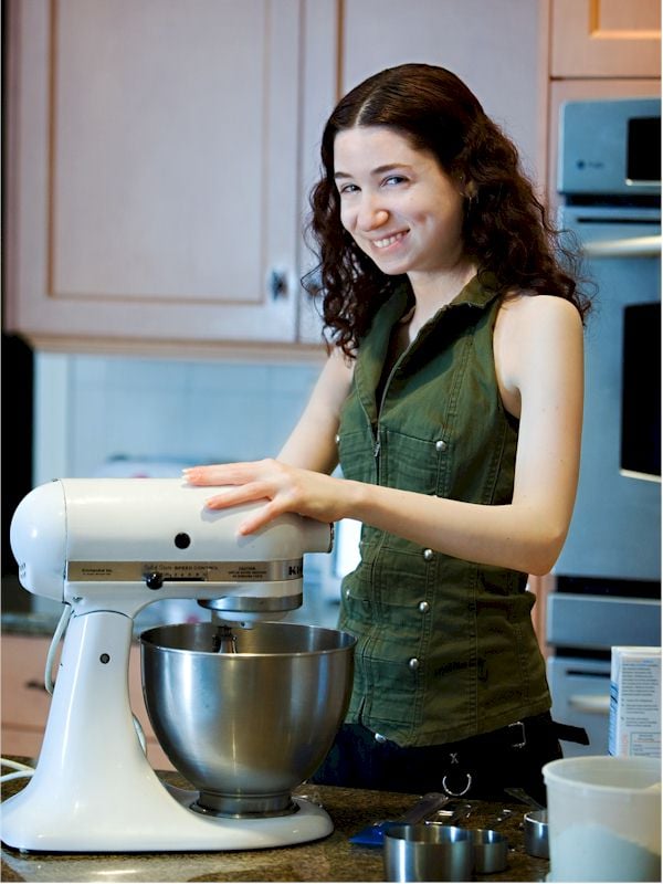 Hannah Kaminsky in a kitchen with a stand mixer.