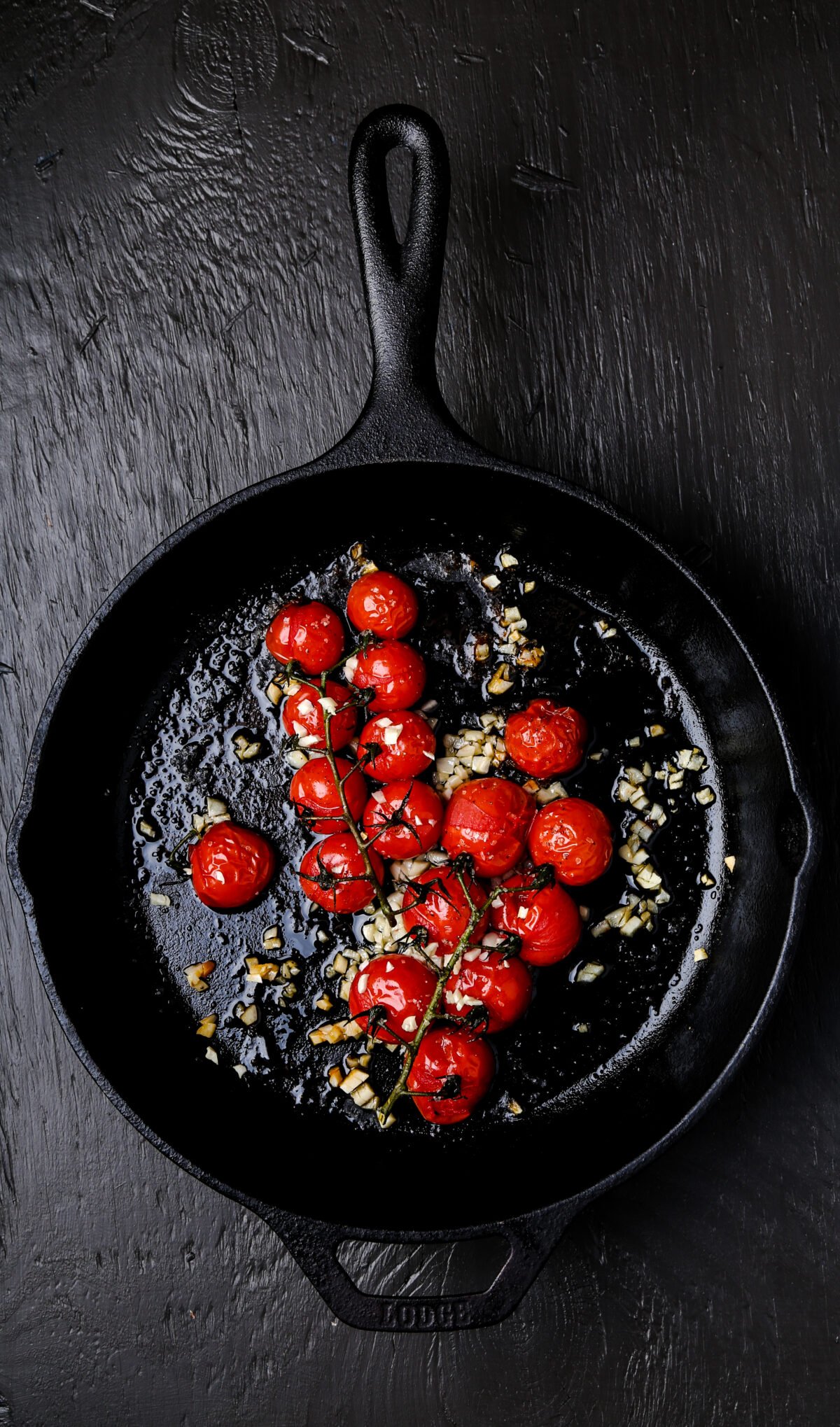 Roasted tomatoes in a cast iron pan.