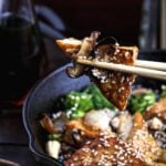 Sticky tofu recipe with sesame seeds and cashews.
