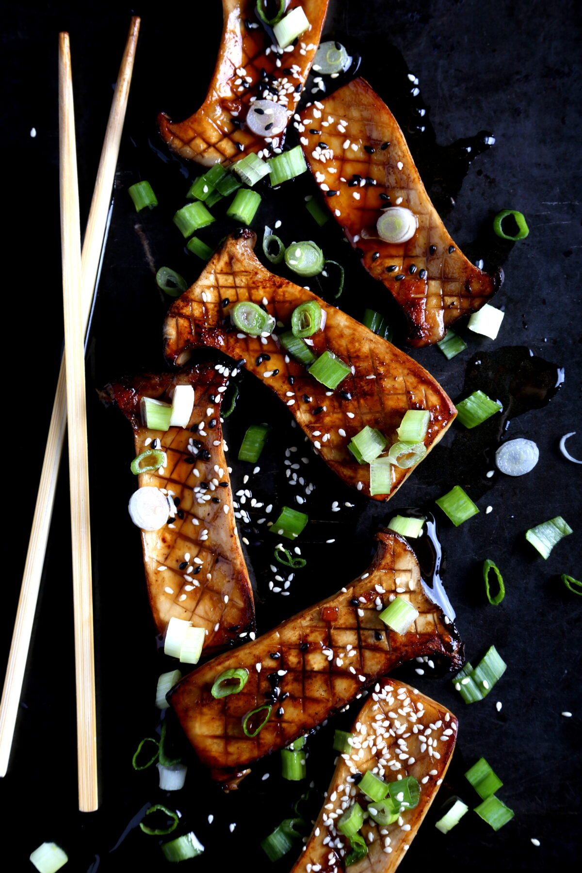 Scored king oyster mushrooms brushed with a rich teriyaki glaze, enhancing umami and sweet flavors.