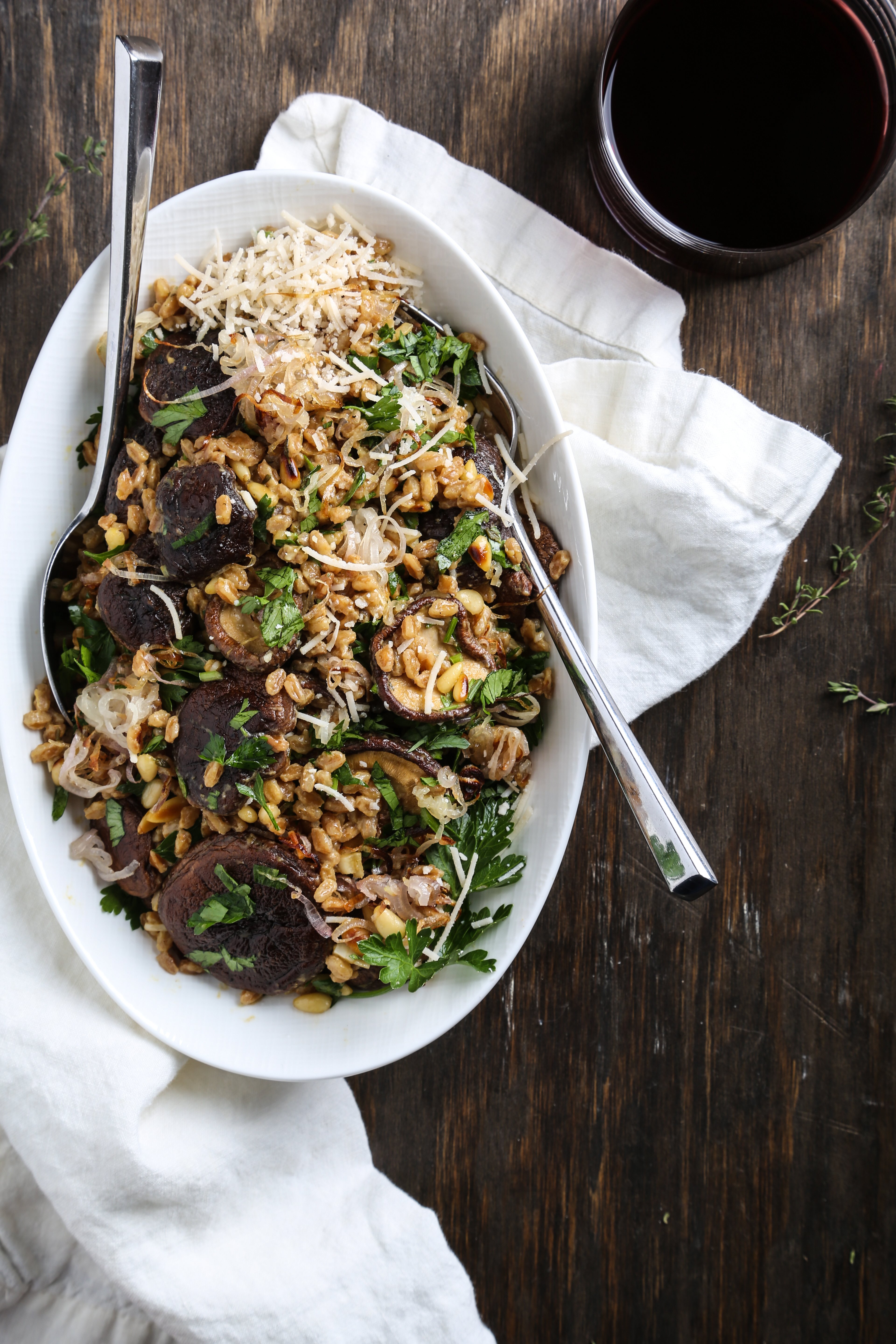 A white bowl of toasted farro salad.