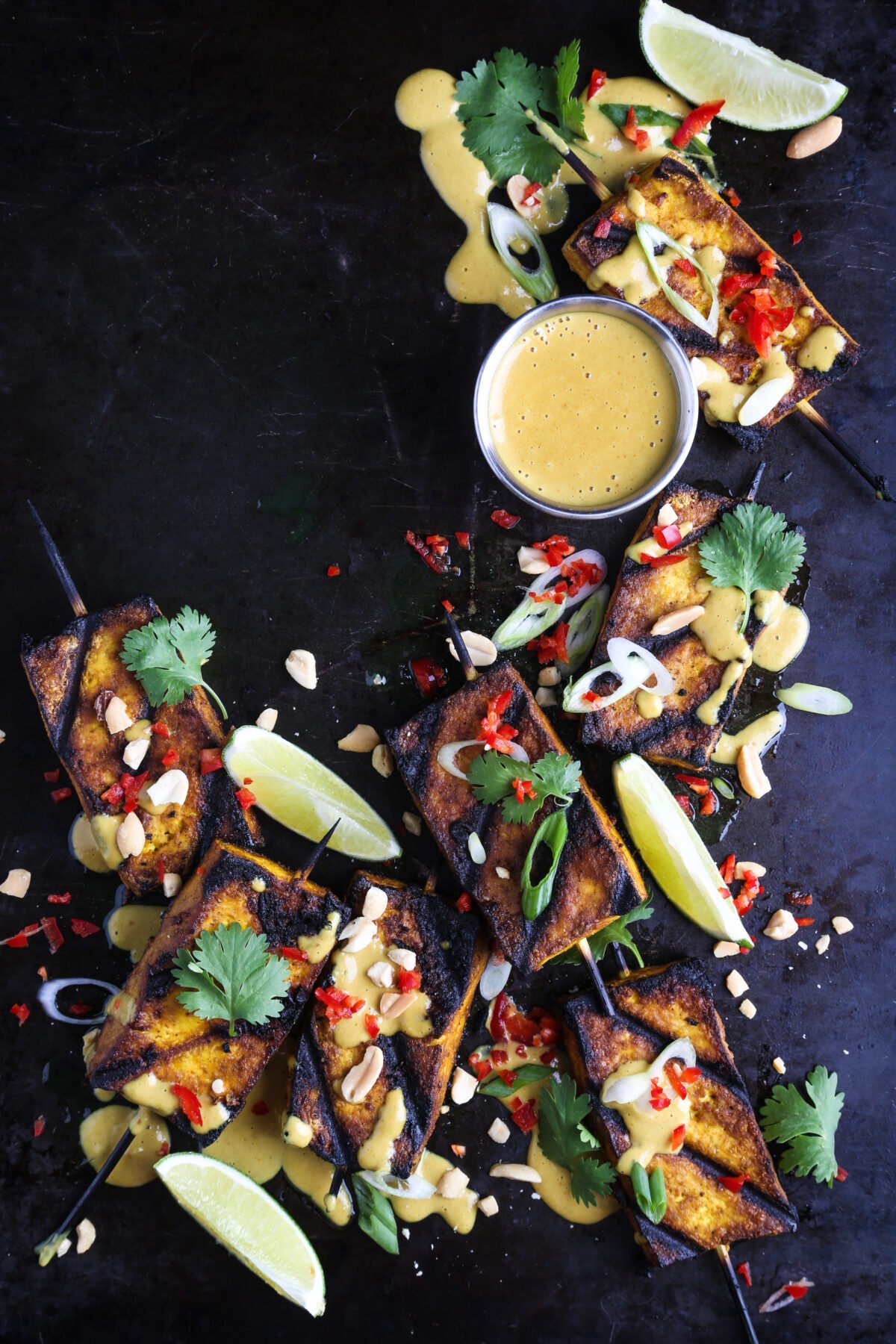 Grilled tofu with vegan peanut sauce, chilis and fresh herbs.