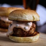 A vegan crab cake slider on a wooden board.