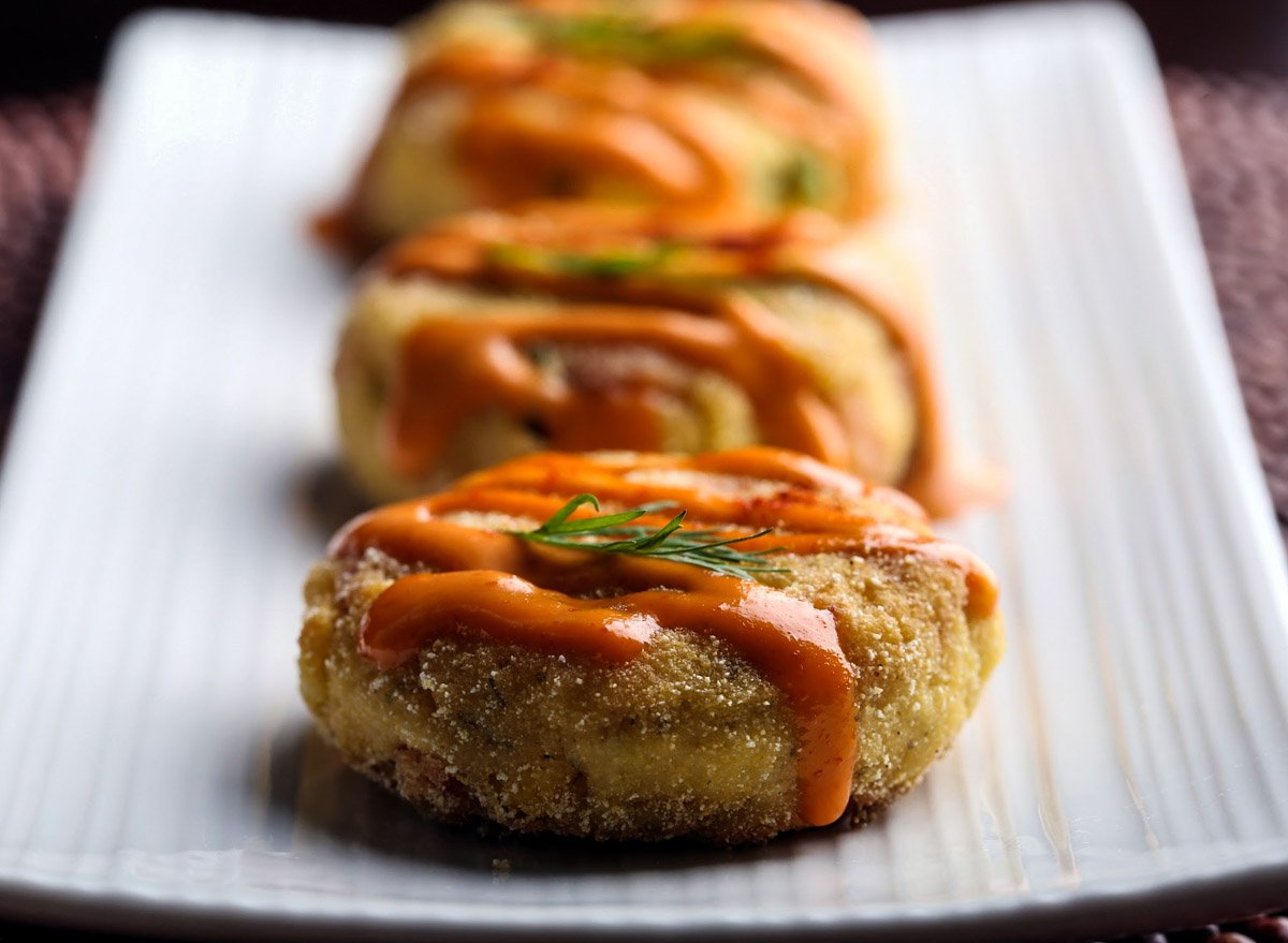 A row of vegan crab cakes on a plate.