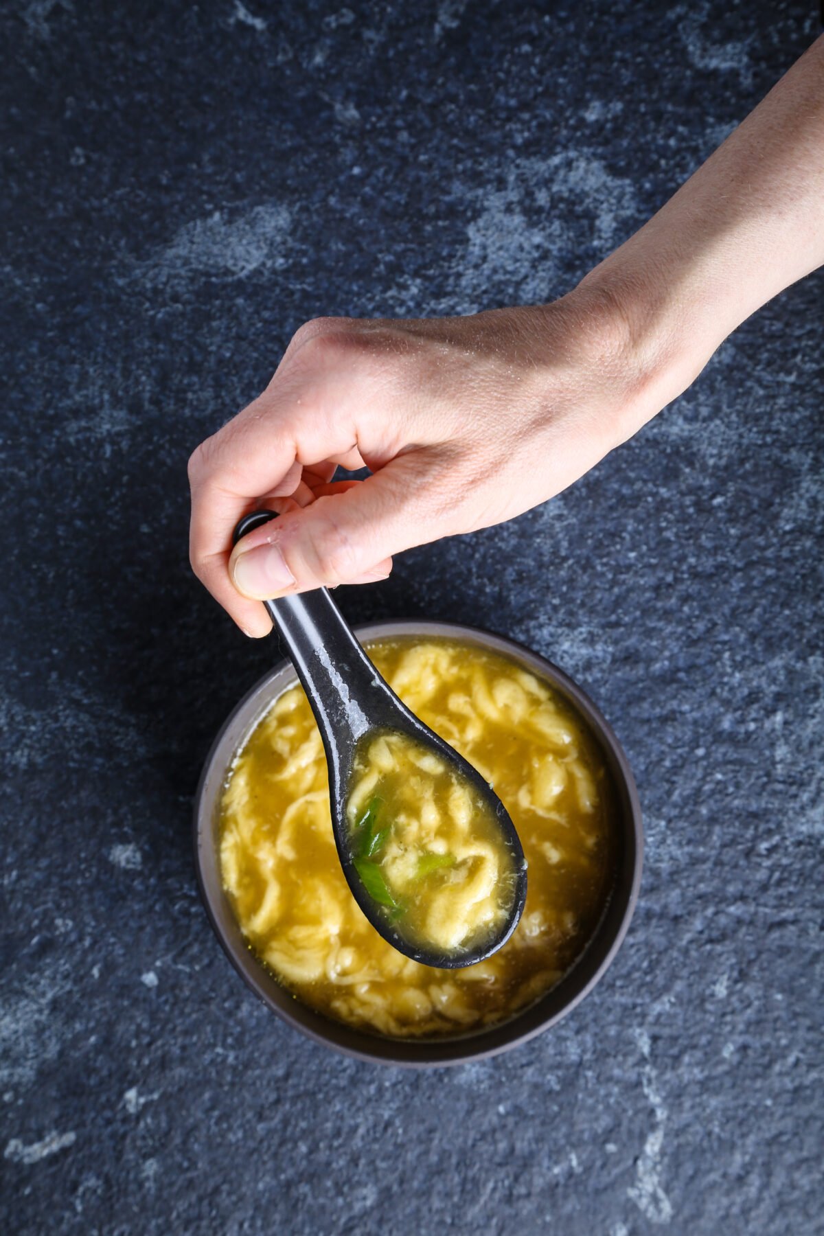 A top-down shot of vegan egg drop soup.