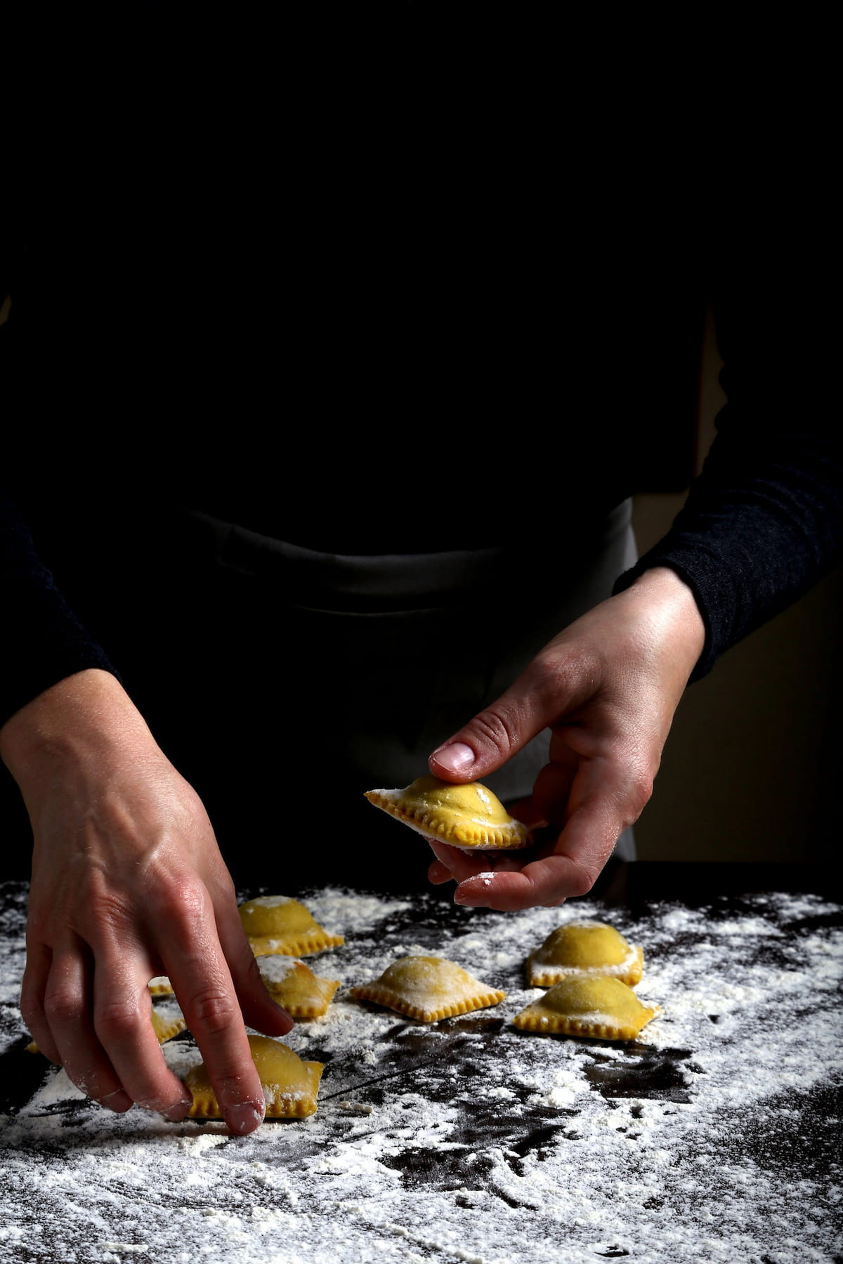 Vegan ravioli being prepped on a floured surface.