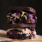 A vegan reuben shot against a dark background.